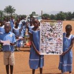 cameroon.shumas.school.environmental.education.programme. Children showing poster of wild animals